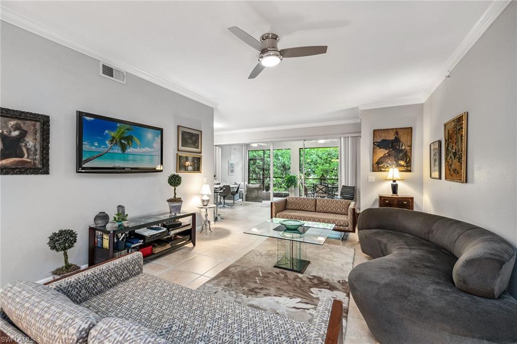 3985 Deer Crossing Court, Unit 103 Naples, FL 34114 - Photo 4 of 37 a living room with furniture or couch and a window