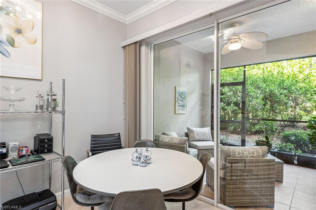 3985 Deer Crossing Court, Unit 103 Naples, FL 34114 - Photo 7 of 37 a dining room with furniture and window