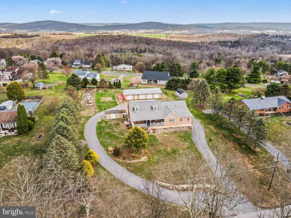 an aerial view of a house with a mountain