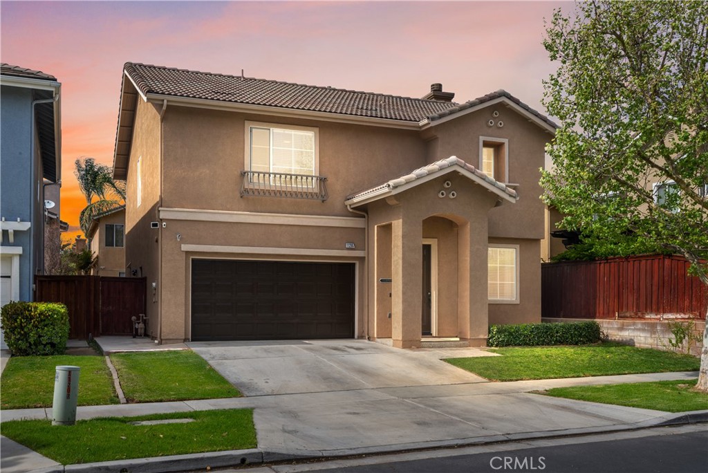 11207 Parkscape Drive Riverside, CA 92505 - Photo 1 of 1 a front view of a house with a yard and garage