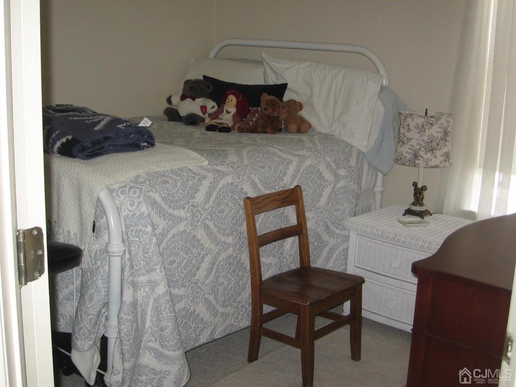 1708 Ridgeview Court Sayreville, NJ 08859 - Photo 15 of 24 a bedroom with a bed and a chair