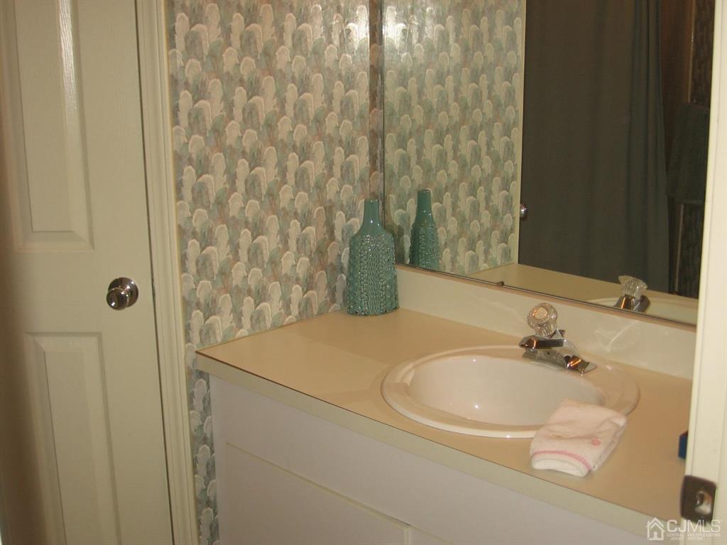 1708 Ridgeview Court Sayreville, NJ 08859 - Photo 18 of 24 a bathroom with a sink and a mirror