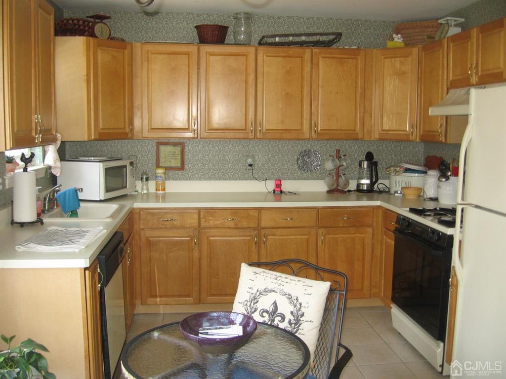 1708 Ridgeview Court Sayreville, NJ 08859 - Photo 2 of 24 a kitchen with stainless steel appliances wooden cabinets sink and a granite counter top