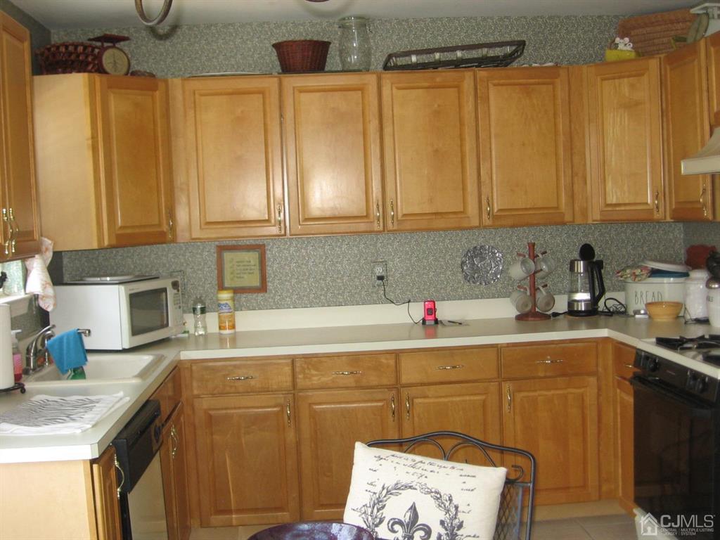 1708 Ridgeview Court Sayreville, NJ 08859 - Photo 7 of 24 a kitchen with a sink a cabinets and appliances