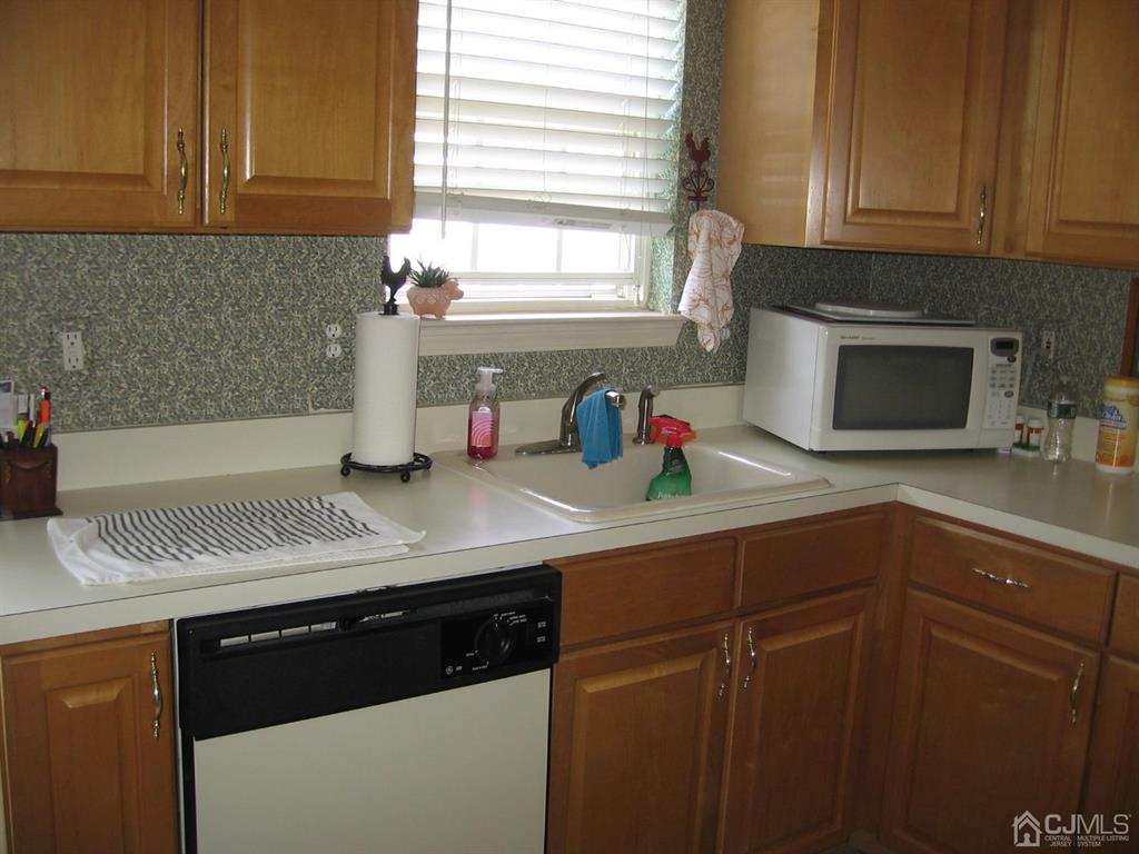 1708 Ridgeview Court Sayreville, NJ 08859 - Photo 8 of 24 a kitchen with stainless steel appliances granite countertop a sink dishwasher a stove and a microwave oven with cabinets