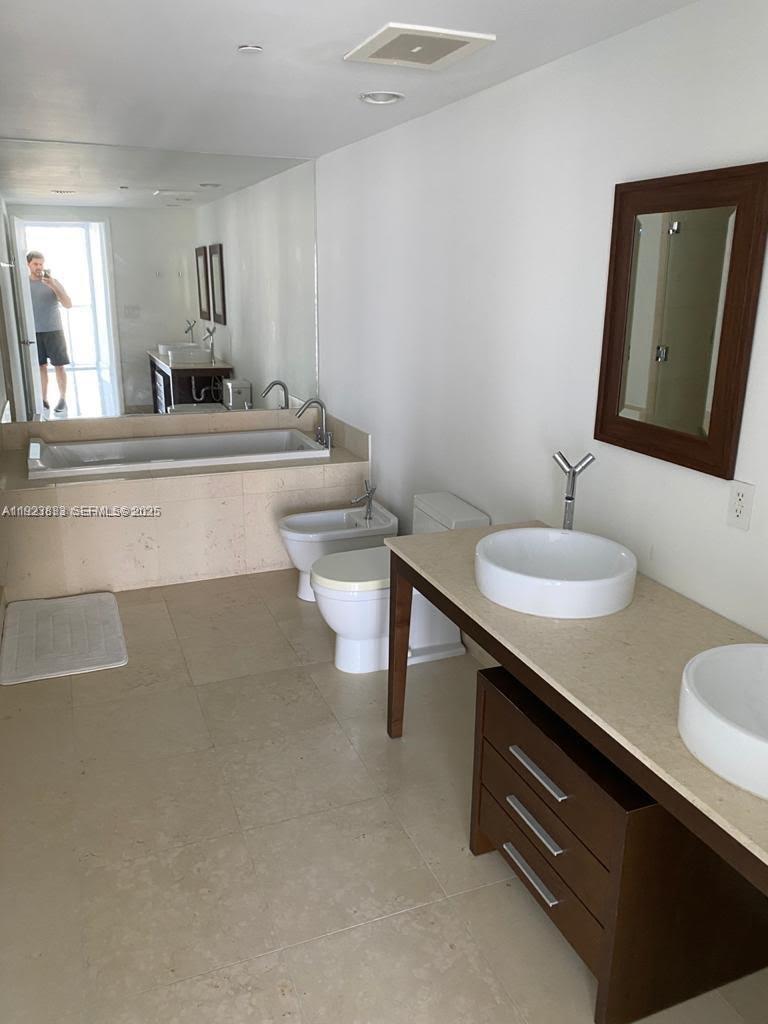 495 Brickell Avenue, Unit 2902 Miami, FL 33131 - Photo 13 of 31 a bathroom with a sink a toilet and mirror