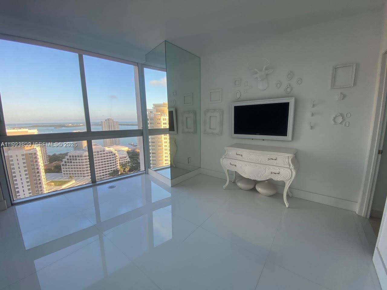 495 Brickell Avenue, Unit 2902 Miami, FL 33131 - Photo 16 of 31 a living room with furniture and a flat screen tv