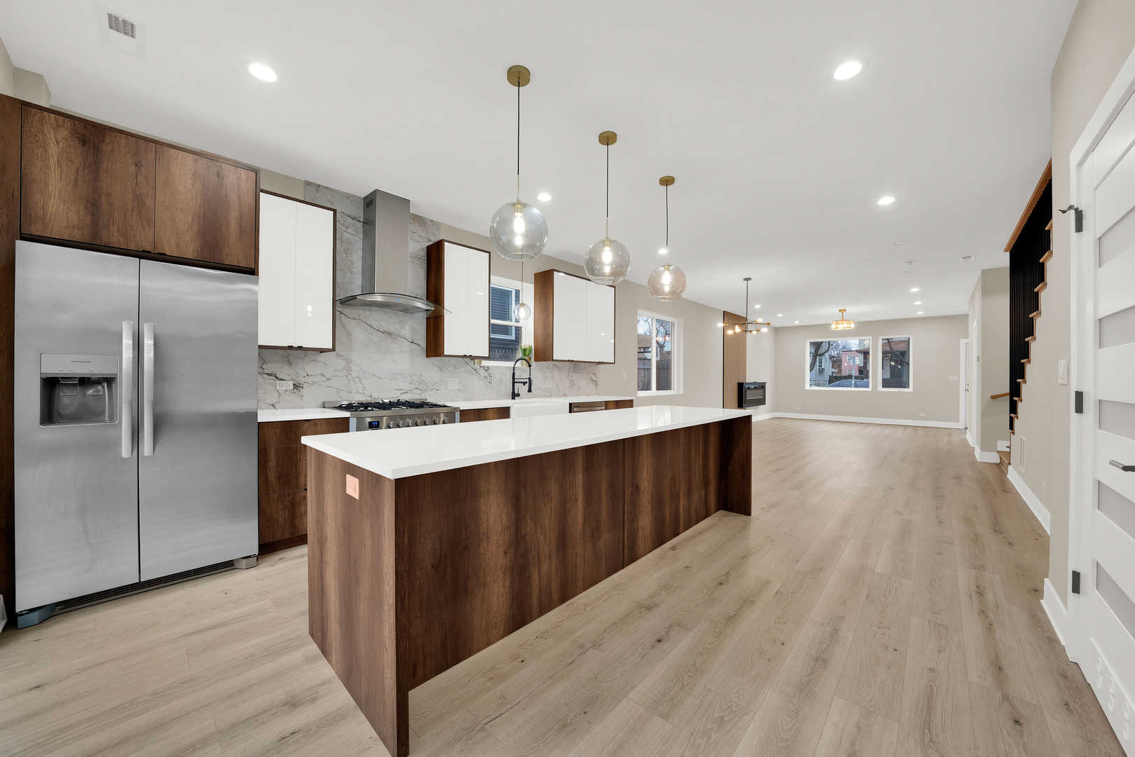 5901 West Erie Street Chicago, IL 60644 - Photo 12 of 38 a large kitchen with stainless steel appliances kitchen island granite countertop a large counter top and wooden floor