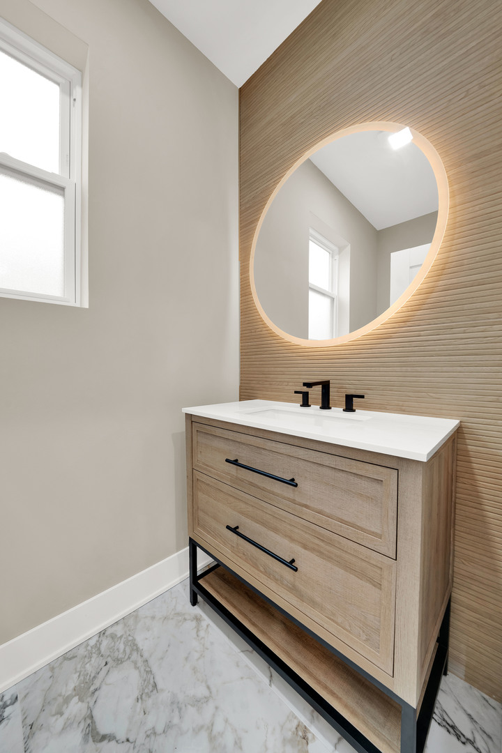 5901 West Erie Street Chicago, IL 60644 - Photo 16 of 38 a bathroom with a sink mirror and vanity
