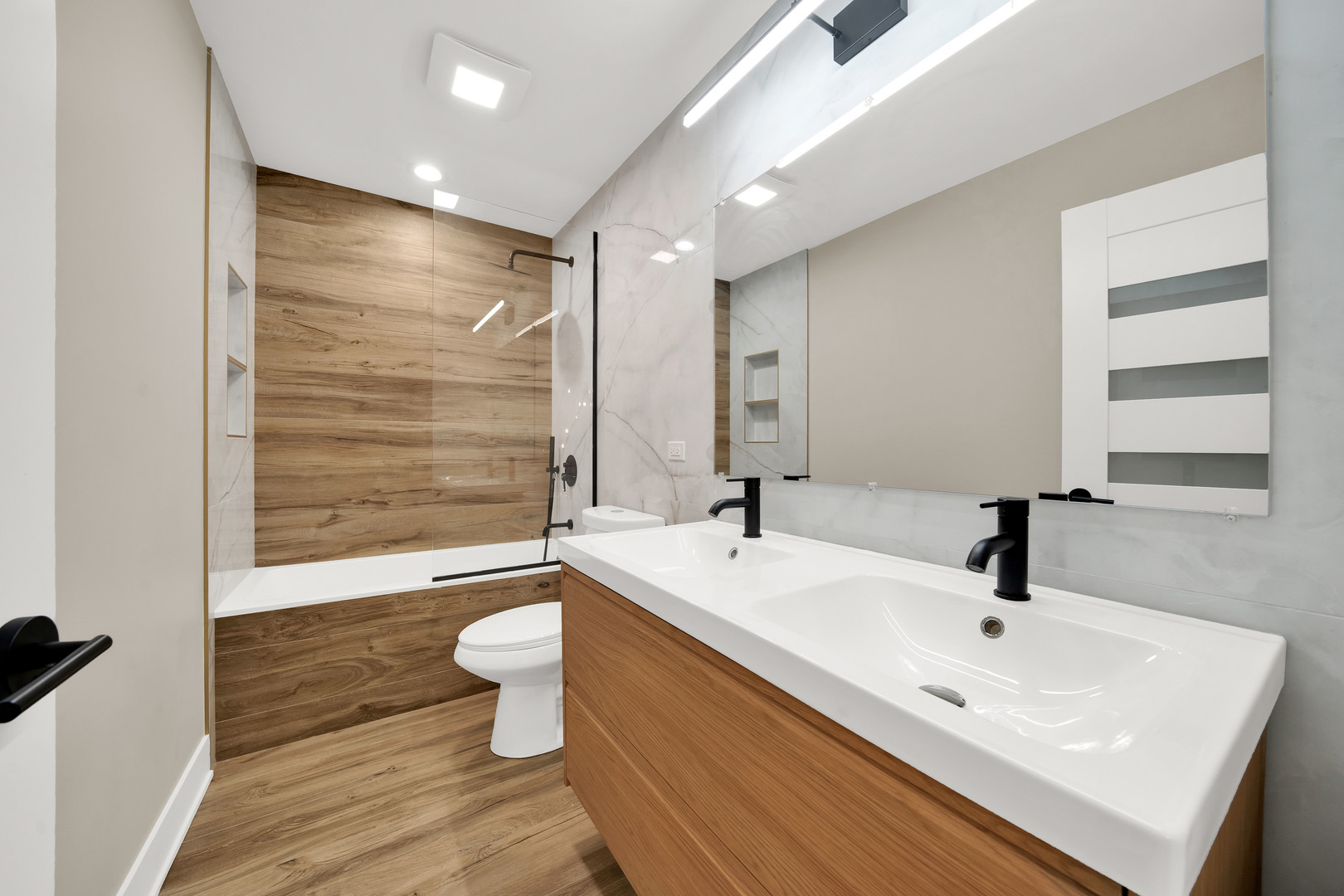 5901 West Erie Street Chicago, IL 60644 - Photo 30 of 38 a bathroom with a sink a toilet and shower