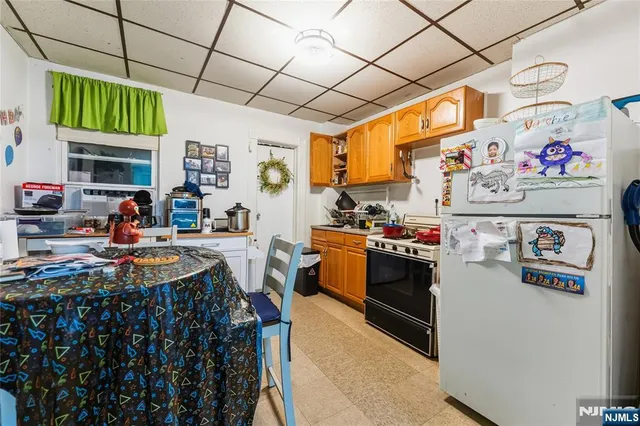 a kitchen with stainless steel appliances granite countertop a stove and a refrigerator