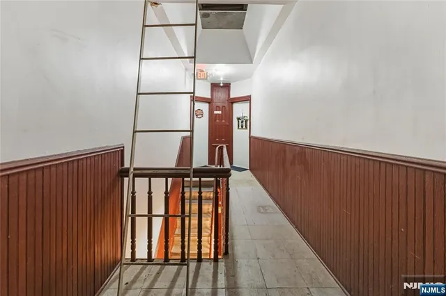 a view of staircase with wooden floor and white walls