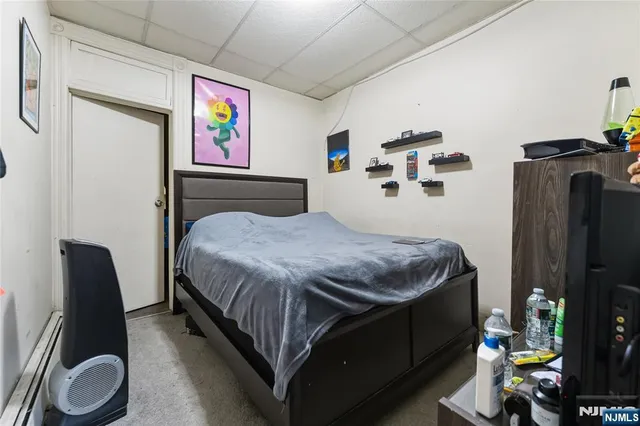 a bedroom with a bed garage and window
