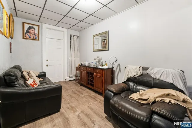 a living room with furniture and dresser