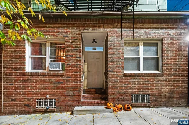 a front view of a building with a couple of windows