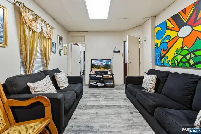 a living room with furniture and painting on the wall