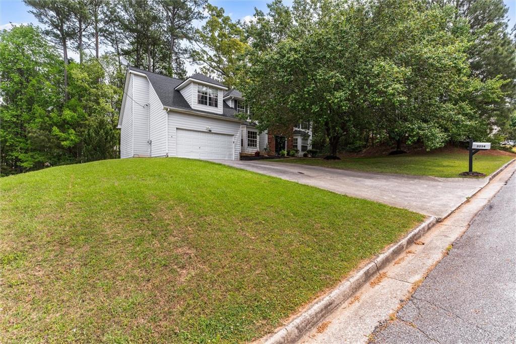 3234 Mineral Ridge Lane Stone Mountain, GA 30087 - Photo 51 of 55 a view of a backyard with a garden
