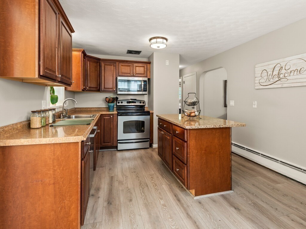 27 Whitla Drive Worcester, MA 01604 - Photo 8 of 38 a kitchen with stainless steel appliances granite countertop a stove a sink dishwasher and a refrigerator