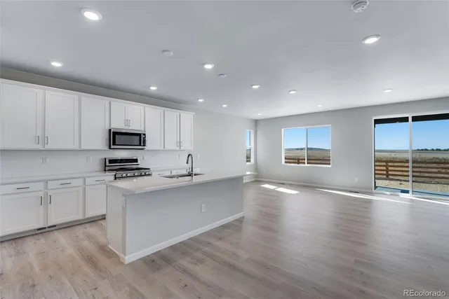 a view of kitchen with sink and wooden floor