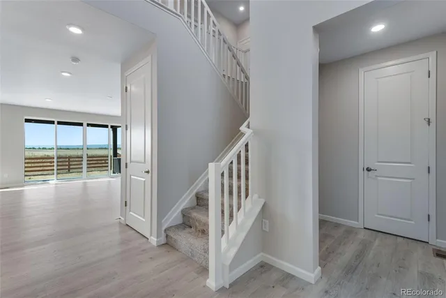 a view of an entryway with wooden floor