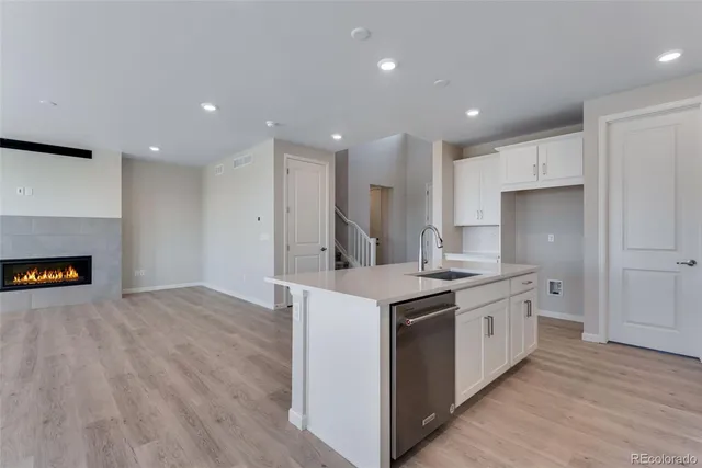 a kitchen with a sink and a refrigerator