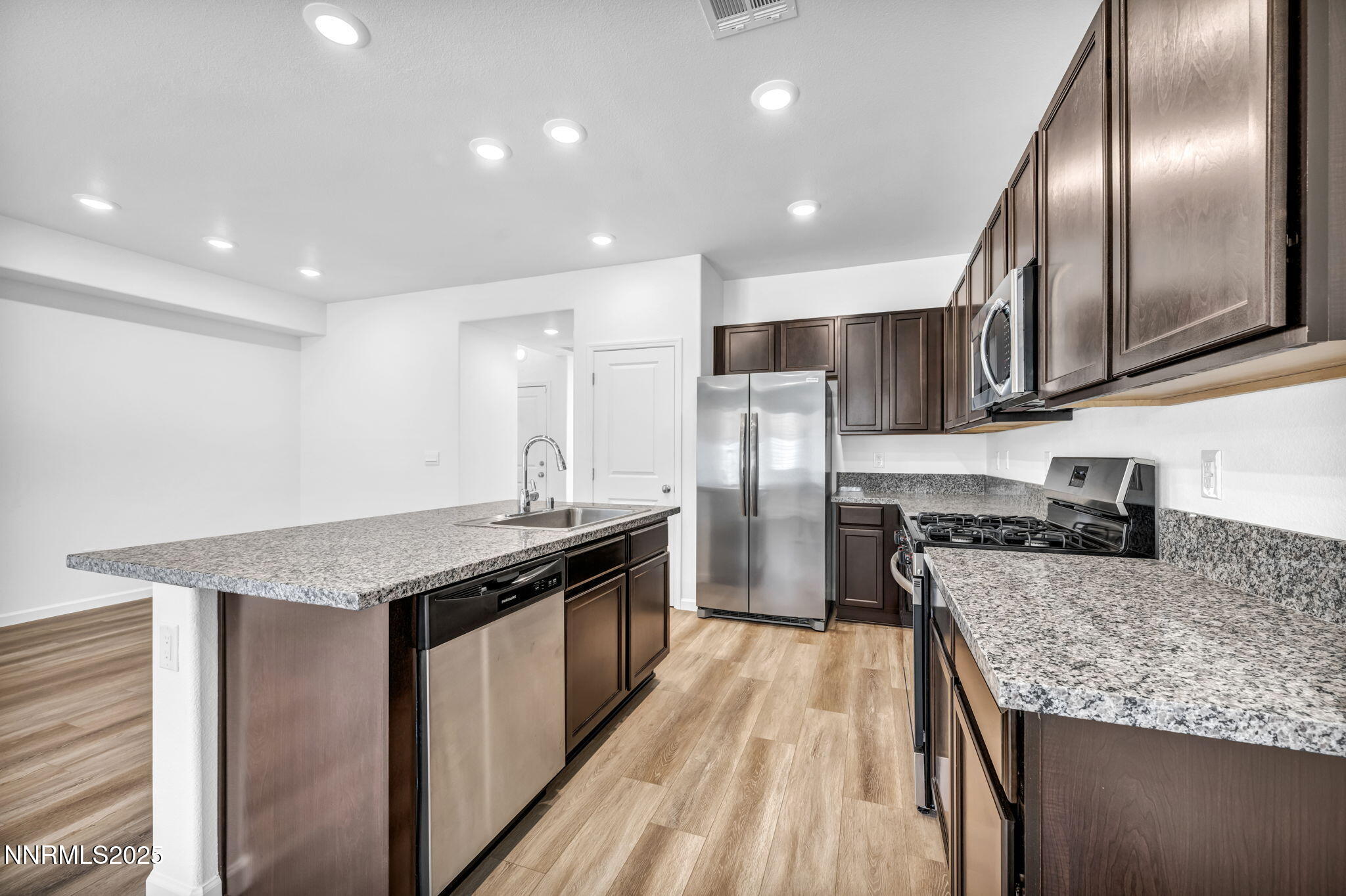 700 Kess Way Reno, NV 89506 - Photo 39 of 53 a kitchen with granite countertop stainless steel appliances lots of counter top space and refrigerator