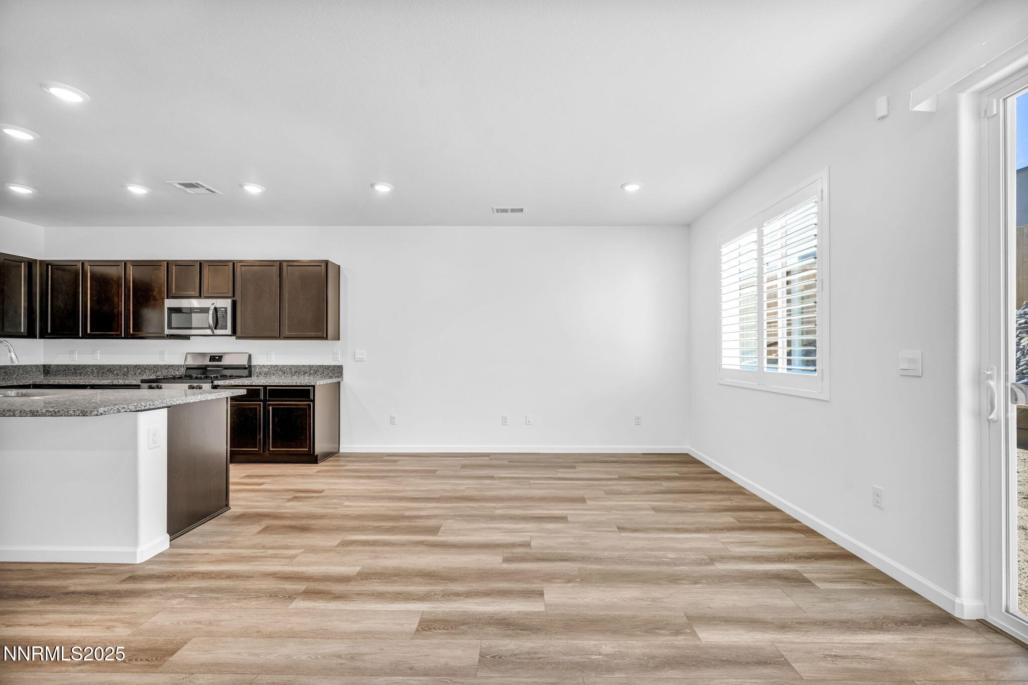 700 Kess Way Reno, NV 89506 - Photo 45 of 53 a kitchen with stainless steel appliances kitchen island granite countertop a stove and a sink