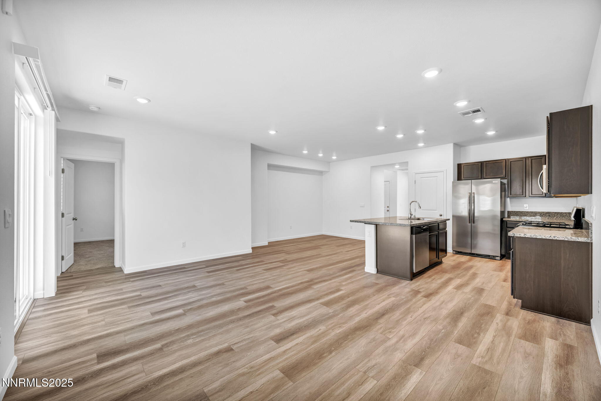700 Kess Way Reno, NV 89506 - Photo 47 of 53 a open kitchen with kitchen island a sink dishwasher stove with wooden floors