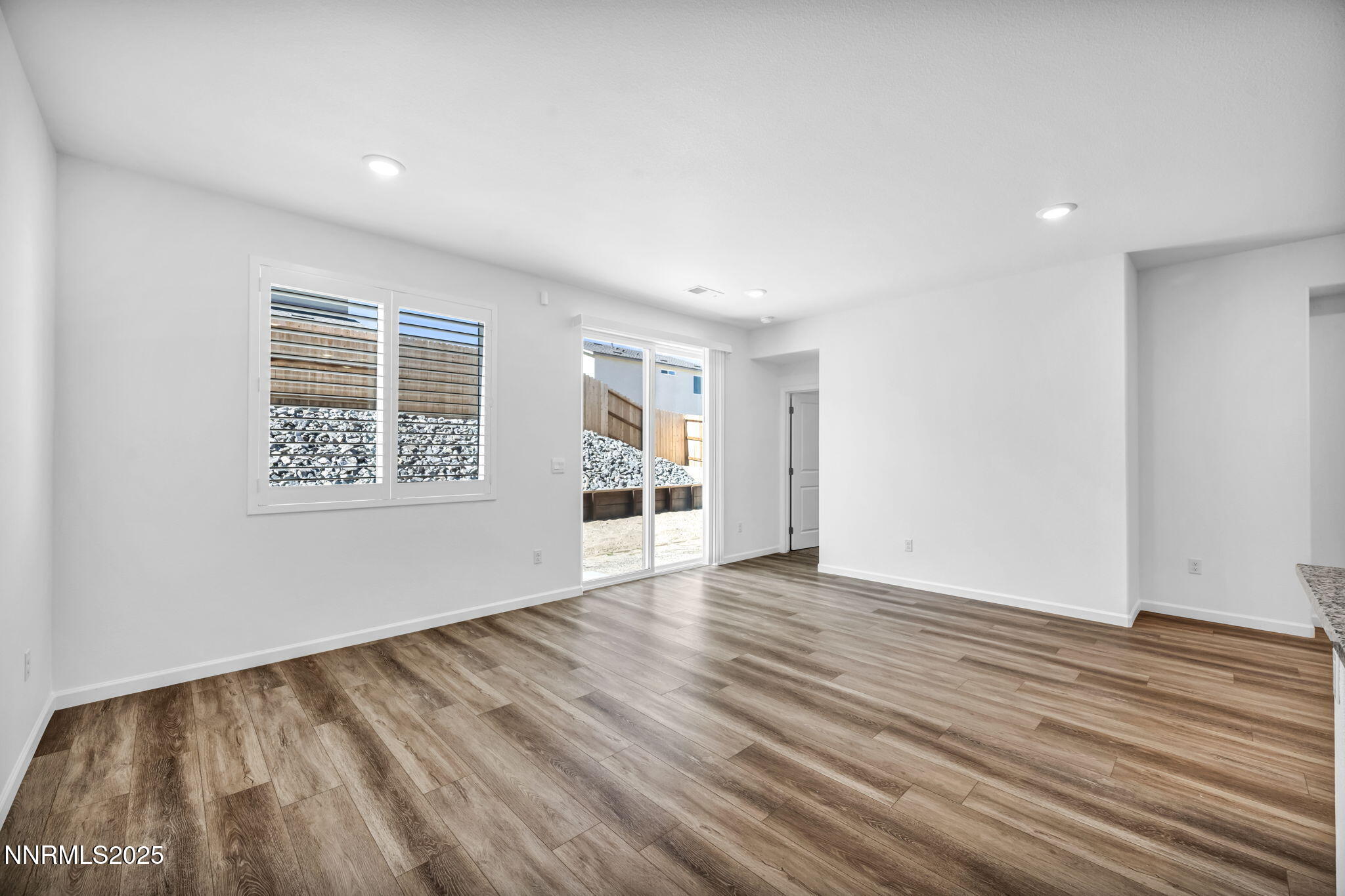 700 Kess Way Reno, NV 89506 - Photo 48 of 53 a view of an empty room with wooden floor and a window