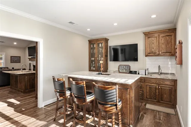a kitchen with a table chairs microwave and cabinets