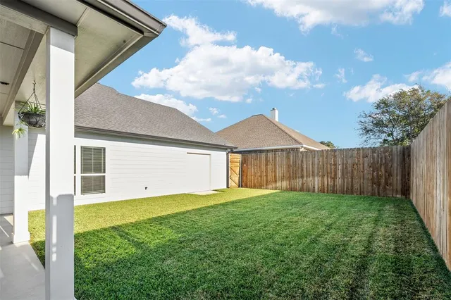 a view of a house with backyard and porch