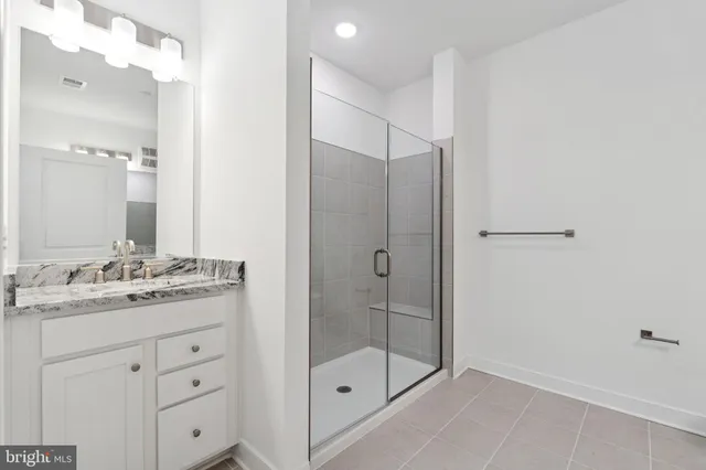 a bathroom with a granite countertop sink mirror and toilet
