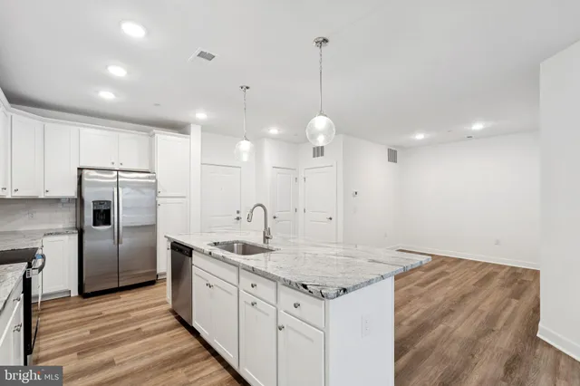 a kitchen with a sink refrigerator and microwave