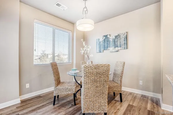 a view of a dining room with furniture and wooden floor