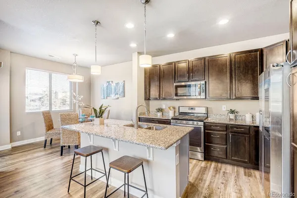 a kitchen with sink cabinets and dining table