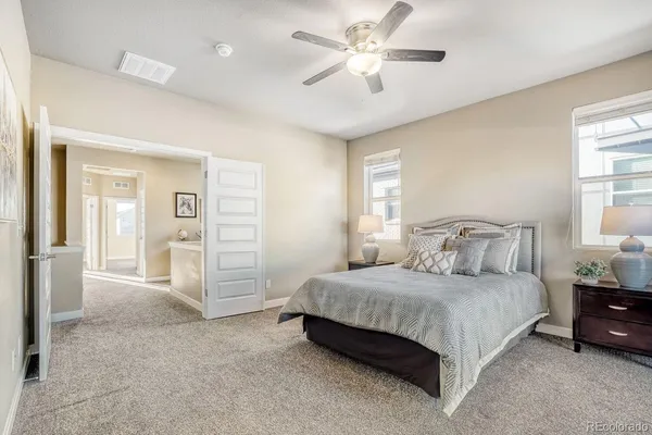 a bedroom with a large bed and a chandelier