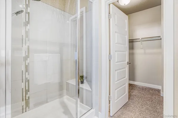 a bathroom with a shower and a glass door