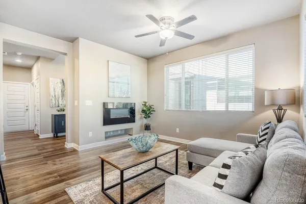 a living room with furniture a table and a large window