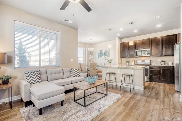 a living room with furniture and kitchen view