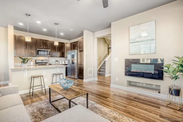 a kitchen with stainless steel appliances kitchen island granite countertop a refrigerator and microwave