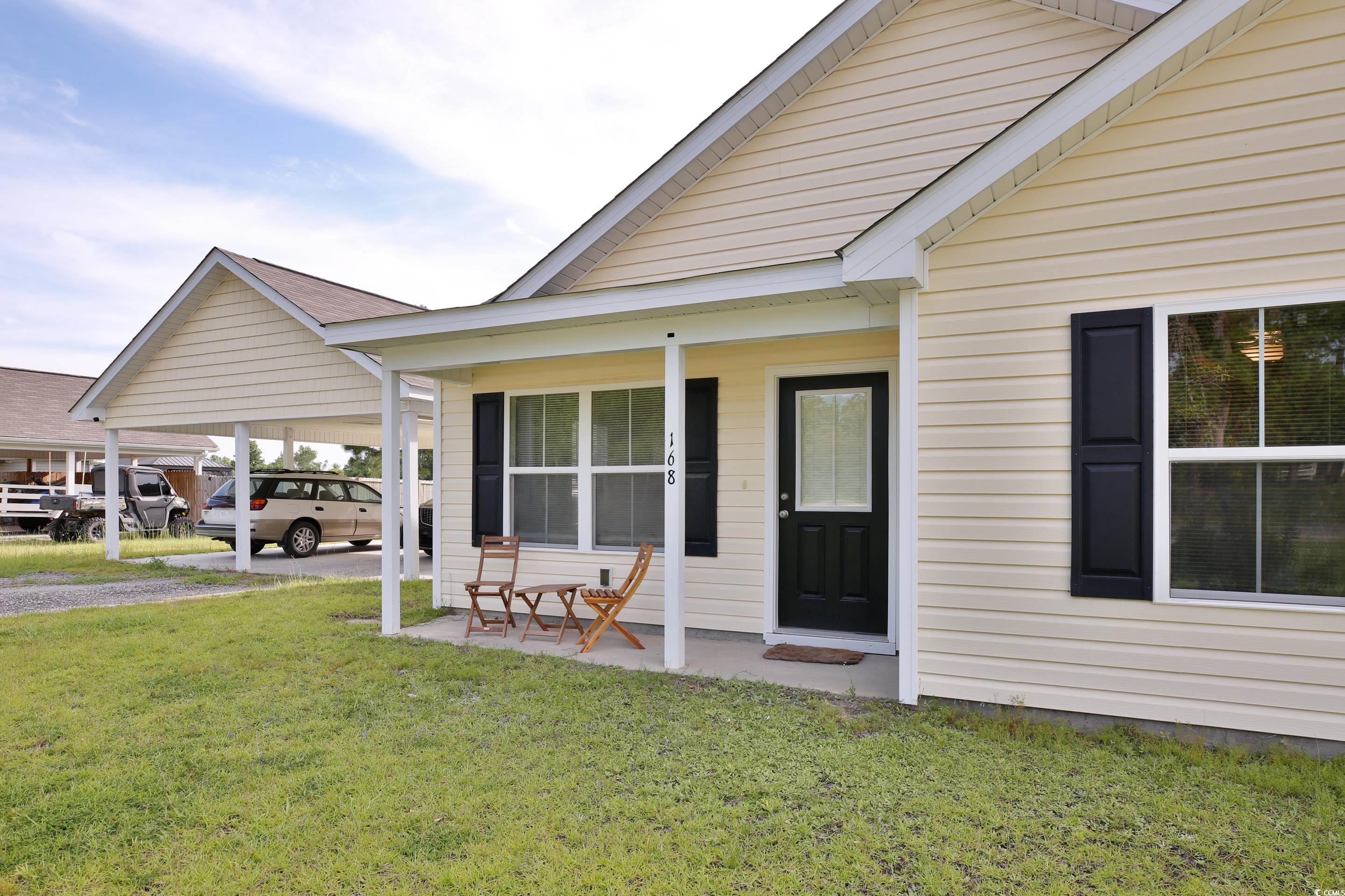 View of exterior entry with a lawn