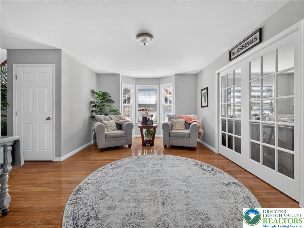 4148 Ross Road Bethlehem, PA 18020 - Photo 41 of 67 Hardwood floors complement this inviting sitting room, bathed in natural light from bay windows.