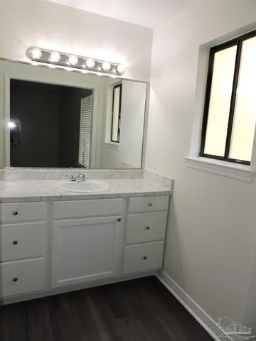 a bathroom with a double vanity sink and mirror