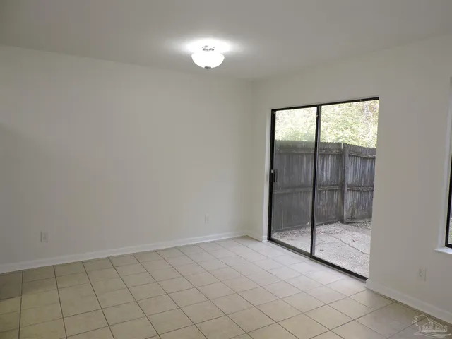 a view of an empty room with glass door