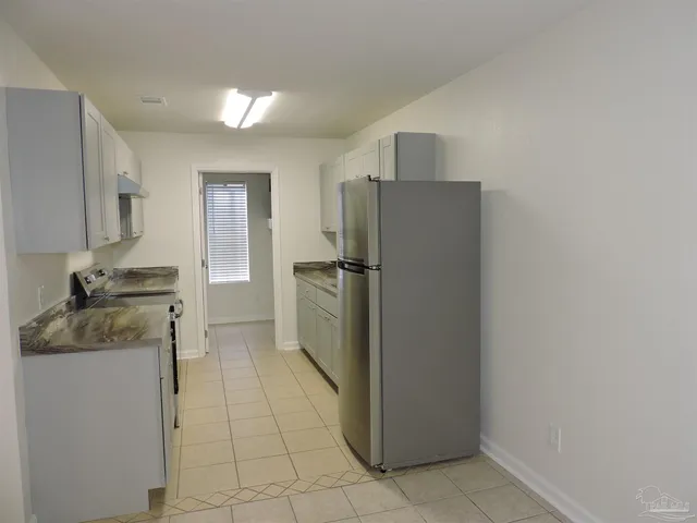 a kitchen with a refrigerator and a sink