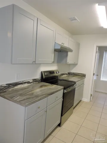 a kitchen with a stove and a sink