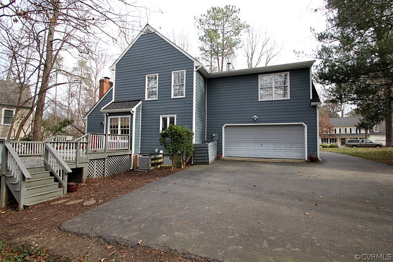 5708 Sandstone Ridge Terrace Midlothian, VA 23112 - Photo 20 of 23 a front view of a house with a yard and garage