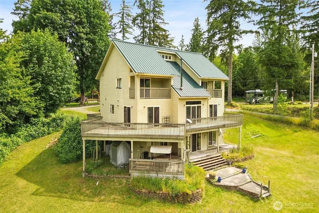 a aerial view of a house with a yard table and chairs