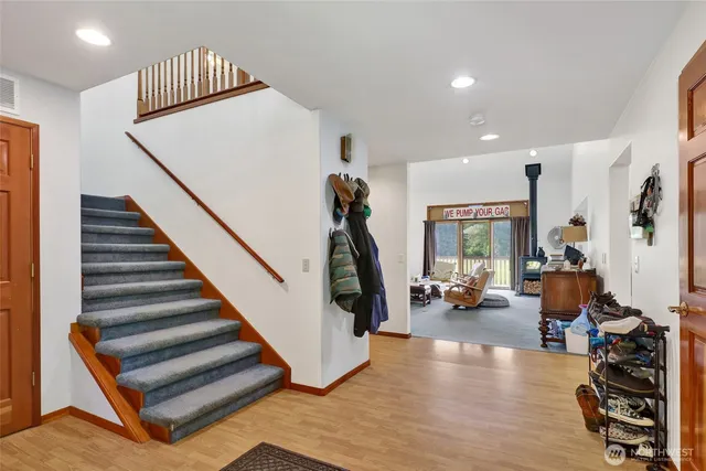 a view of entryway livingroom and hall with wooden floor