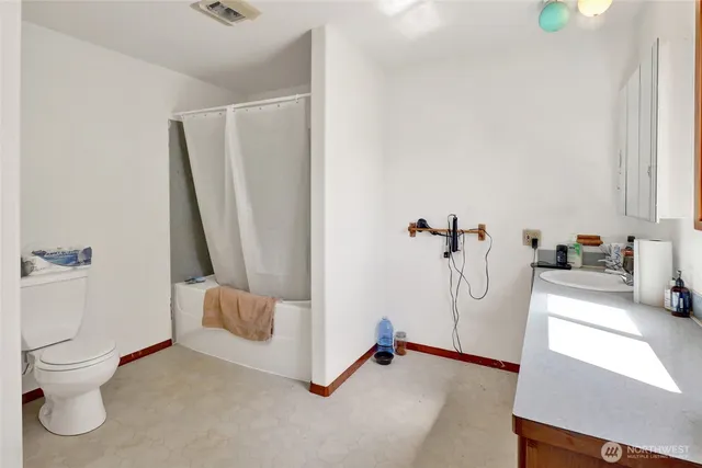 a bathroom with a shower and a toilet